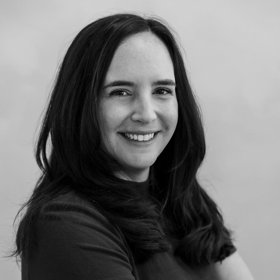 black and white headshot of woman with long hair smiling